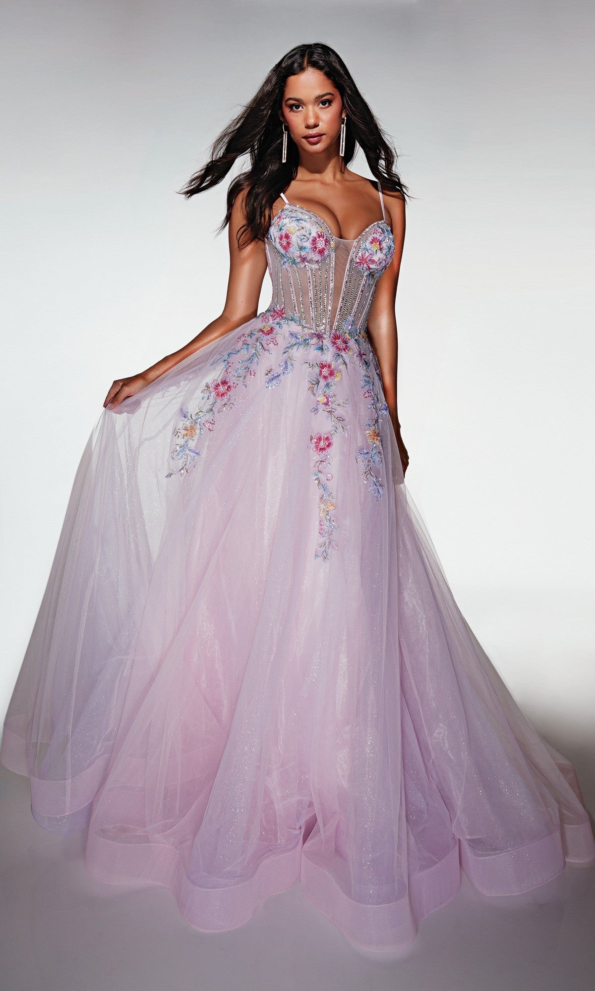 A woman models the Alyce 62068 long prom dress in pink/lilac, featuring a sleeveless floral corset bodice and a full sparkle tulle A-line skirt with delicate embroidery, set against a plain background.